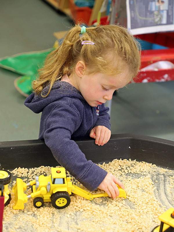 Girl playing in sandpit