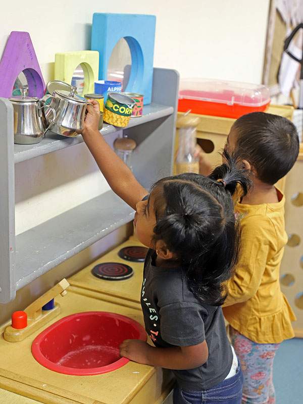 Children playing in kitchen
